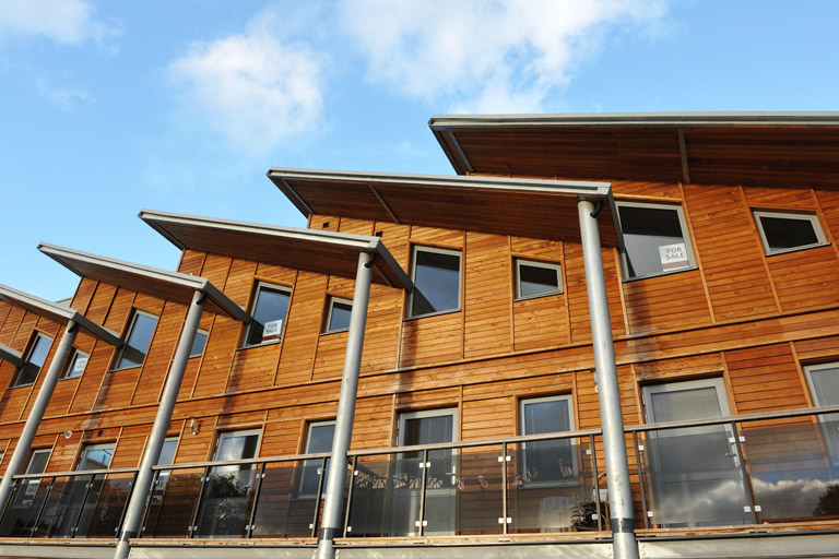 A very modern timber clad terrace with very modern wood windows and wood doors